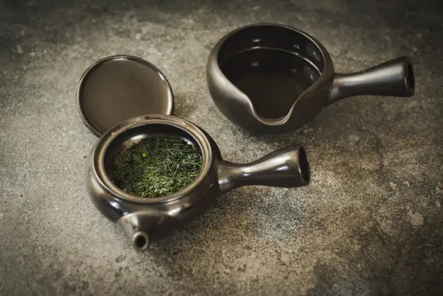 Green tea leaves in a teapot