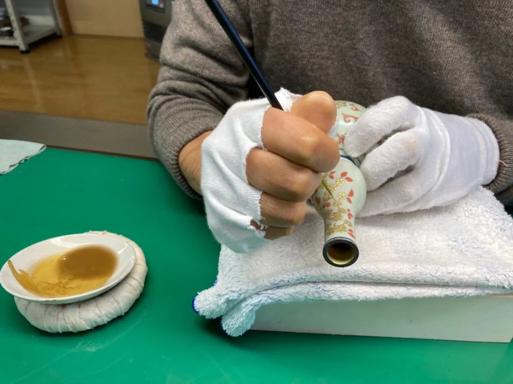 He sources 24-karat gold from Kanazawa and grinds it himself to create the gold pigment for his artwork.